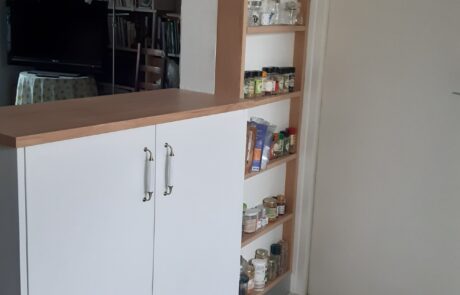 Colonne de rangement sur mesure ouverte dans une cuisine blanche